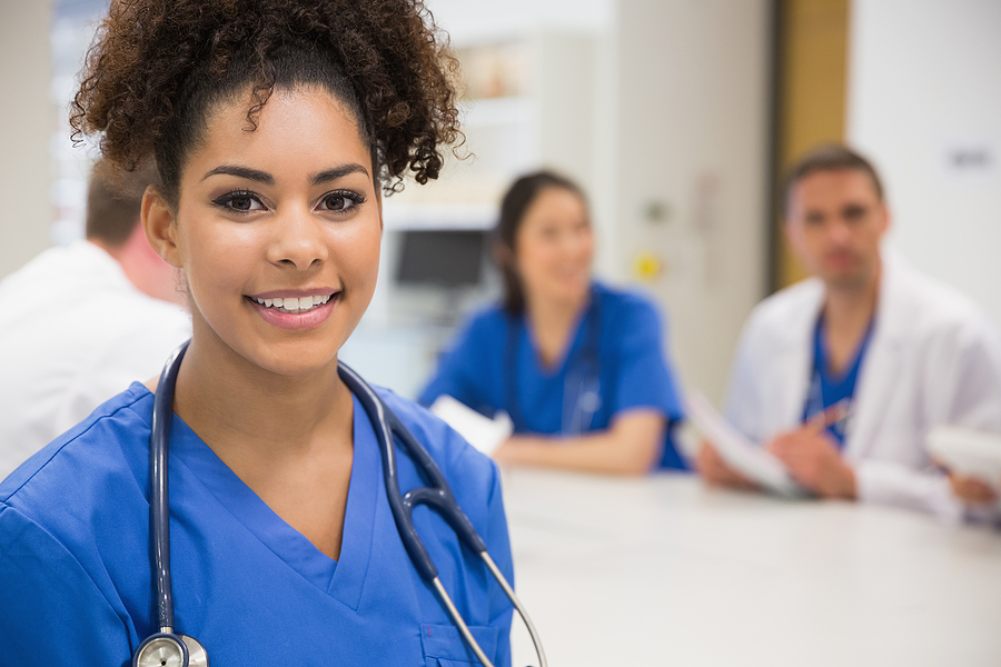 Nurse Educator smiling in classroom with nursing students